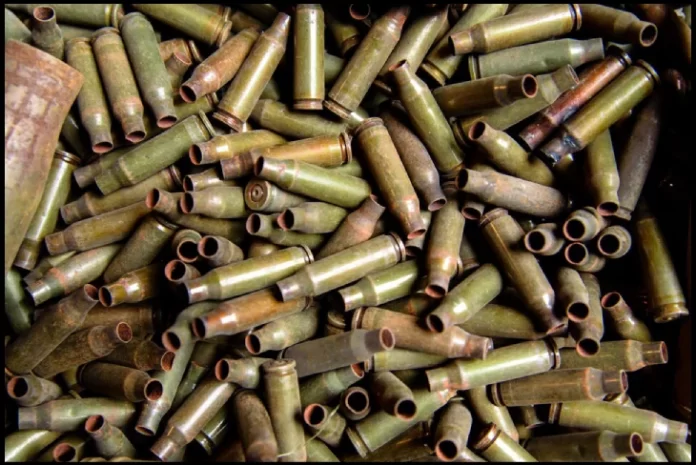 Recycling scrap ammo process showing sorted brass casings and lead bullets ready for reprocessing.